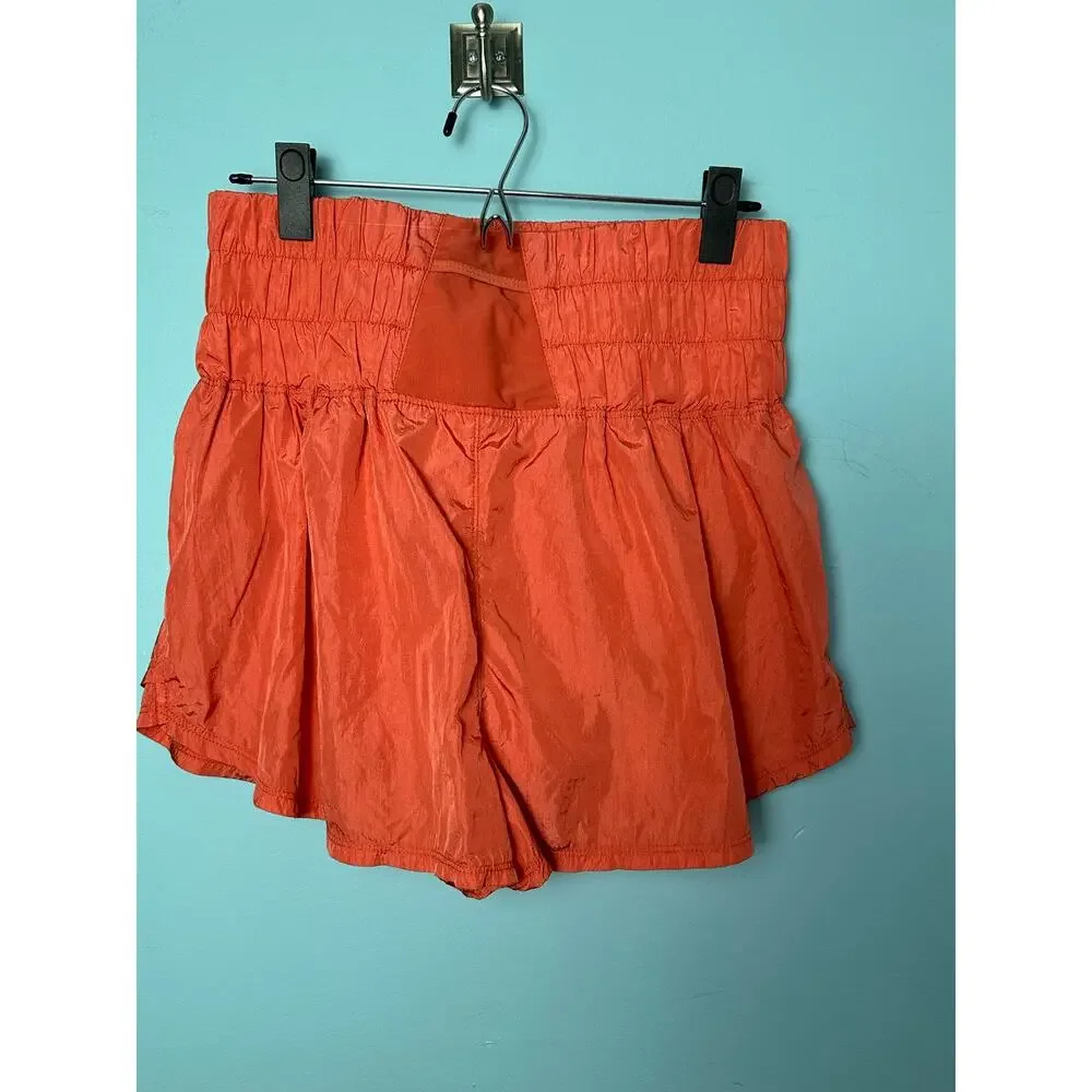 Free People FP Movement Way Home shorts in a vibrant coral reddish-orange color